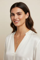 Vikchi Astra Kaia necklace with three princess-cut diamonds in a vertical drop on a 14kt yellow gold chain.