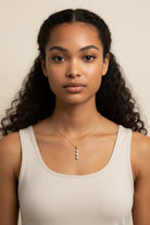 Vikchi Astra Kaia necklace with three princess-cut diamonds in a vertical drop on a 14kt yellow gold chain.