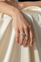 Vikchi Isola Vira Aura Ring: 3.6 ctw emerald-cut diamond center stone with tapered baguette side stones in 14K gold.